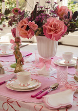 Elegant dining setup featuring a Casa by Josephine Jenno Nibbles Bowl surrounded by floral decorations