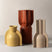 Set of three modern ceramic vases in yellow, terracotta, and beige with unique ribbed designs