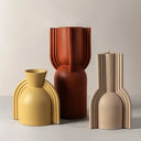 Set of three modern ceramic vases in yellow, terracotta, and beige with unique ribbed designs