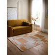 Stylish Nomad Rug with geometric patterns in orange and cream, complementing a modern living room space