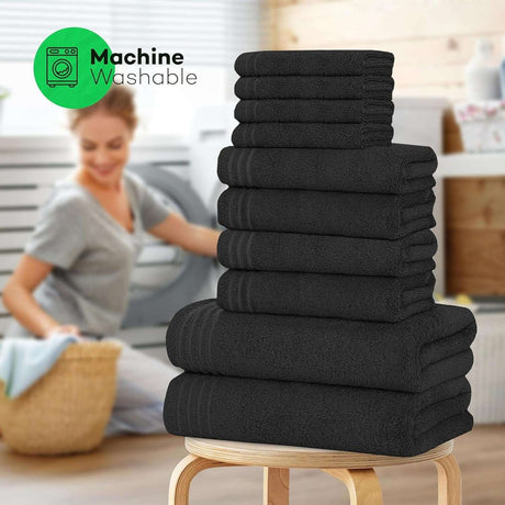 Olivia Rocco Cotton Towels Set in Black, featuring multiple towels in a neatly stacked arrangement