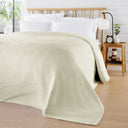 OLIVIA ROCCO Cream Throw Blanket on a Bed for Stylish Home Decor
