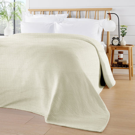 OLIVIA ROCCO Cream Throw Blanket on a Bed for Stylish Home Decor