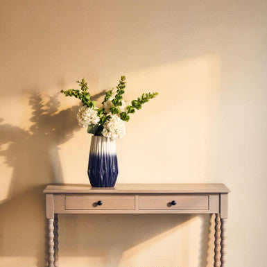 Orsina Ombre Vase in a chic design, adorned with white flowers on a wooden console table