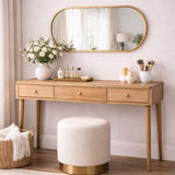 Elegant oval mirror from Jobu Home above a wooden console table adorned with decor and plants