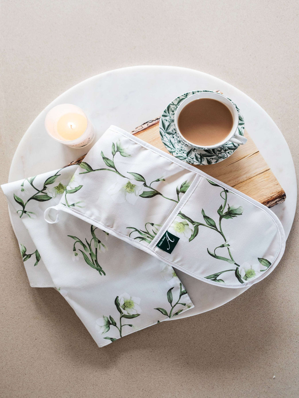 Avalon Home UK Floral Oven Glove and Matching Tea Towel Set on a Marble Surface with a Cup of Tea