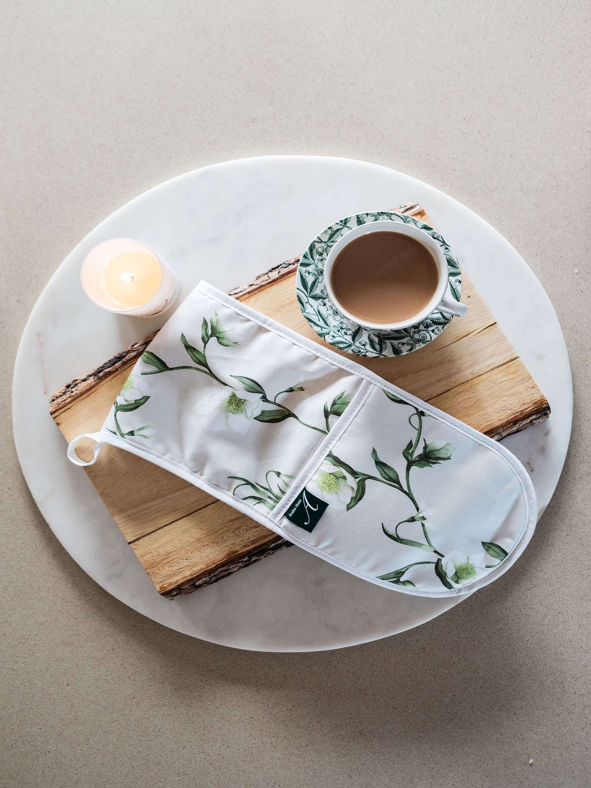 Avalon Home UK Floral Oven Glove on a Wooden Board with a Candle and Mug