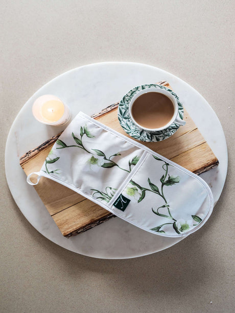 Avalon Home UK Floral Oven Glove on a Wooden Board with a Candle and Mug