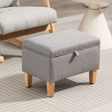 Grey padded footstool with storage and wooden legs, perfect for stylish living rooms