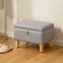 Grey padded footstool with wooden legs, ideal for added comfort and storage in any living space