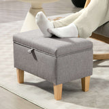 Grey padded footstool with storage and wooden legs, perfect for lounging or as extra seating