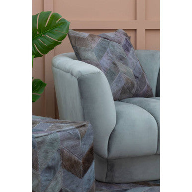 Orsina Patchwork Cushion in muted colours, complementing a modern sofa for stylish home decor
