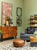 Stylish living room featuring Orsina Patchwork Cushion on a grey sofa with decorative elements