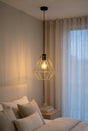 Orsina Pendant Light with a geometric design illuminating a stylish bedroom interior