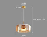 Nisu Home Pendant Light with Amber Glass Shade and Gold Finish, perfect for modern interiors