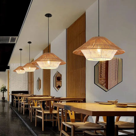 Stylish pendant light fixtures in a modern restaurant setting with wooden tables and walls