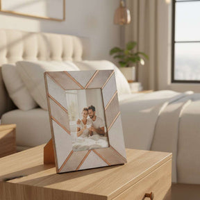 Orsina Photo Frame with a geometric design displaying a couple's photo in a modern bedroom setting