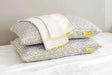 Brightr Sleep adjustable pillows with a grey geometric design and a white cover, paired with a Pillow Protector