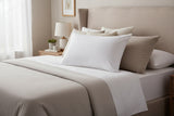 Luxurious Pillow from PillowPillow on a neatly made bed with soft bedding and decorative cushions