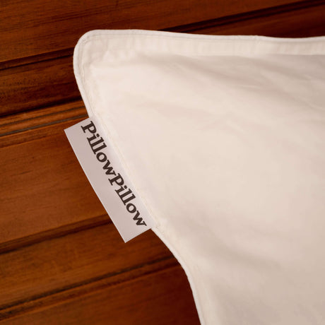 PillowPillow branded pillow corner showing soft fabric and tag for comfortable sleep