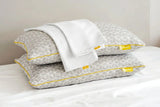 Brightr Sleep Memory Foam Hybrid Pillow with a Pillowcase Bundle on a bed for optimal neck support