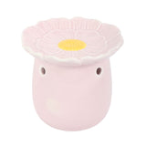 Pink ceramic oil burner in flower shape for fragrant essential oils and home aromatherapy