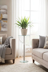 Elegant plant stand featuring a glass top and decorative beaded detail, perfect for indoor plants