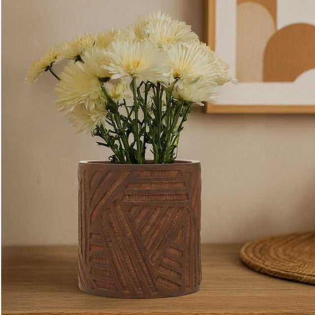 Orsina ceramic planter with textured design, holding fresh white flowers for indoor decor