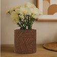 Orsina ceramic planter with textured design, holding fresh white flowers for indoor decor