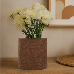 Orsina ceramic planter with textured design, holding fresh white flowers for indoor decor