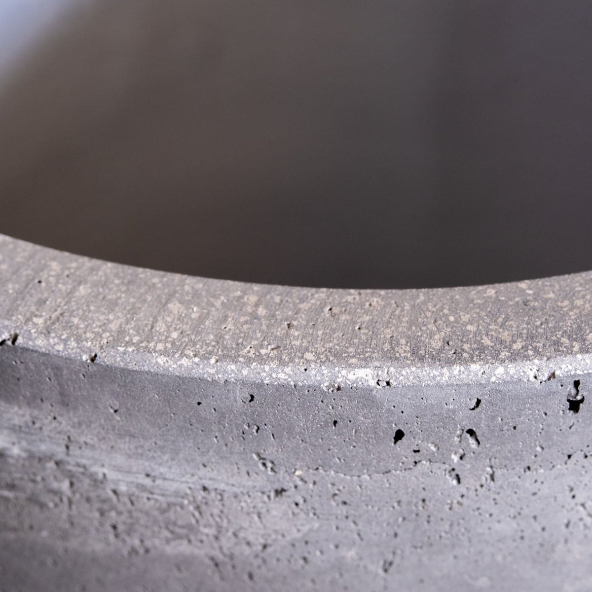 Close-up view of Jobu Home concrete planter showcasing textured finish and unique design