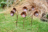 Handcrafted metal Poppy Flower garden stakes adding artistic flair to outdoor spaces