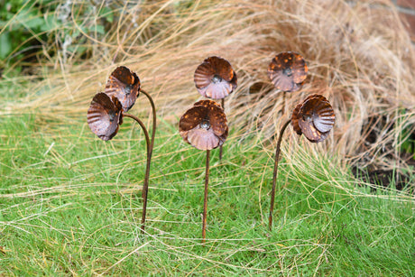 Handcrafted metal Poppy Flower garden stakes adding artistic flair to outdoor spaces