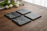 Selbrae House Slate Placemat Set featuring elegant hare designs on a rustic wooden table