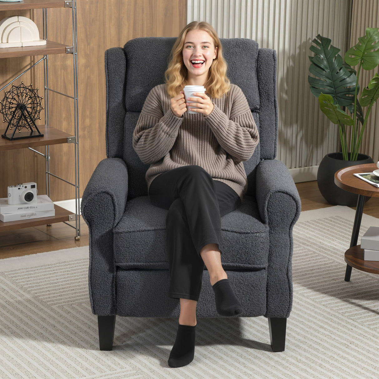 Comfortable recliner armchair by Wise Galleria with a cosy design and a woman enjoying a drink