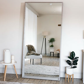 Jobu Home Rectangle Mirror with a wooden frame reflecting modern living room decor