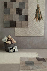 Orsina Rectangular Cushion in various designs displayed with rugs and a basket for home decor