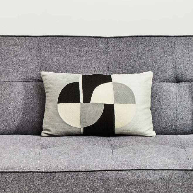 Orsina Rectangular Cushion with a stylish geometric design placed on a grey sofa