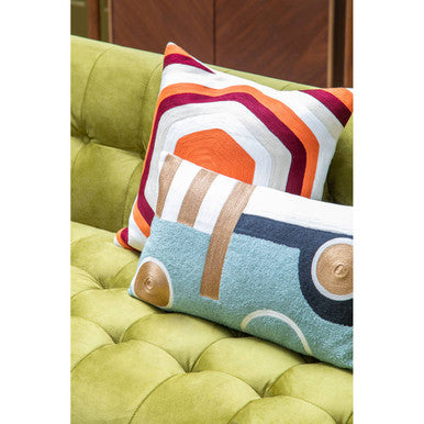Orsina Rectangular Cushion in Blue and Brown on a Green Sofa with Decorative Patterns