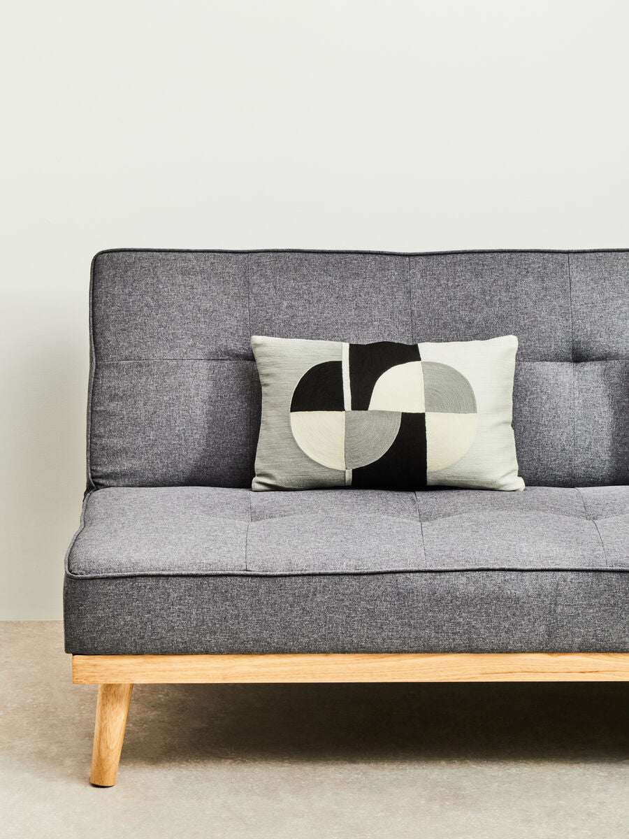 Orsina Rectangular Cushion with a modern geometric design on a grey sofa