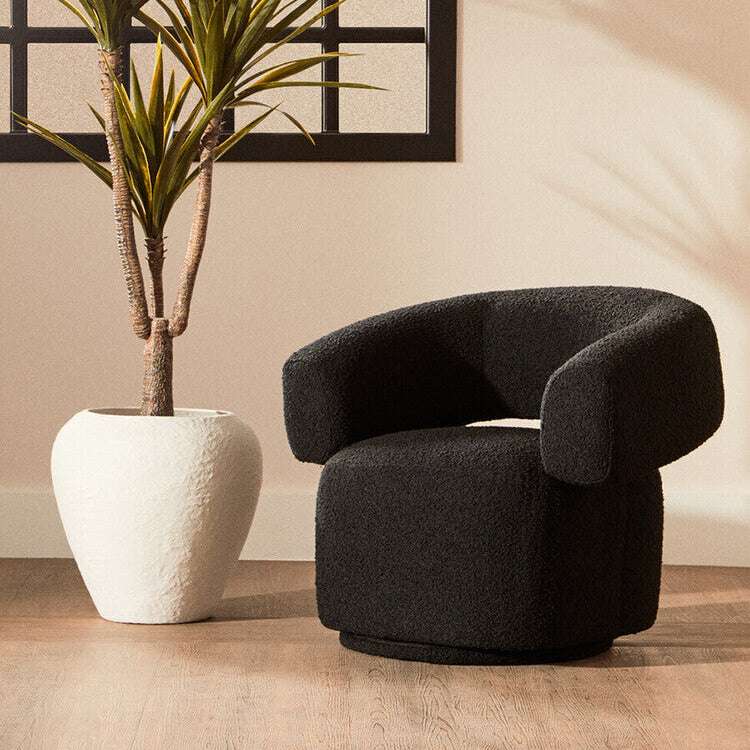 Stylish Orsina revolving armchair in black fabric with rounded design, perfect for modern living spaces