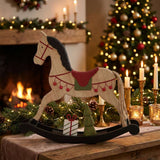 Decorative Rocking Horse Christmas room decoration amidst candles and festive greenery