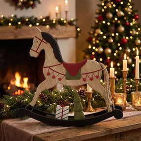 Decorative Rocking Horse Christmas room decoration amidst candles and festive greenery