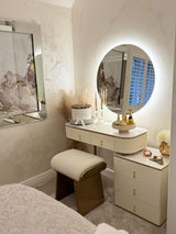 Stylish Round Mirror with LED Lighting above a chic vanity in a modern bedroom setting