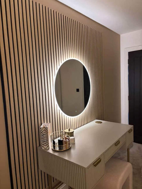 Modern Round Mirror with LED Lights Above Stylish Make-Up Vanity Table in a Contemporary Room