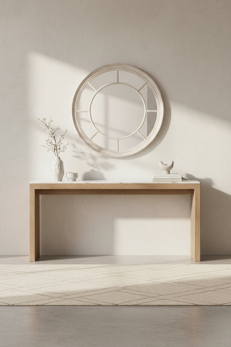 Stylish round mirror above a wooden console table in a minimalist interior setting