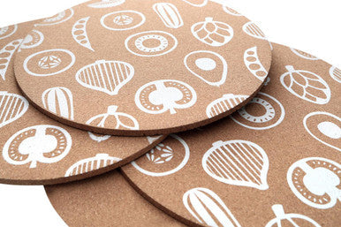 Set of round placemats by Orsina featuring decorative leaf and nut patterns for stylish dining