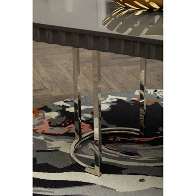 Orsina Round Rug featuring a modern abstract design beneath a sleek metal table