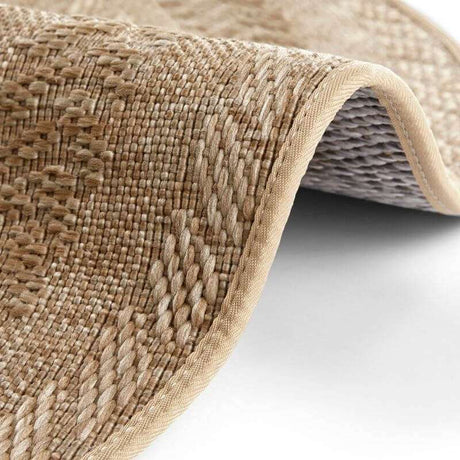 Close-up of a textured Round Rug with a natural woven pattern and edged design for home decor