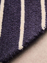 Orsina Round Rug featuring a textured navy and cream striped design for modern interiors